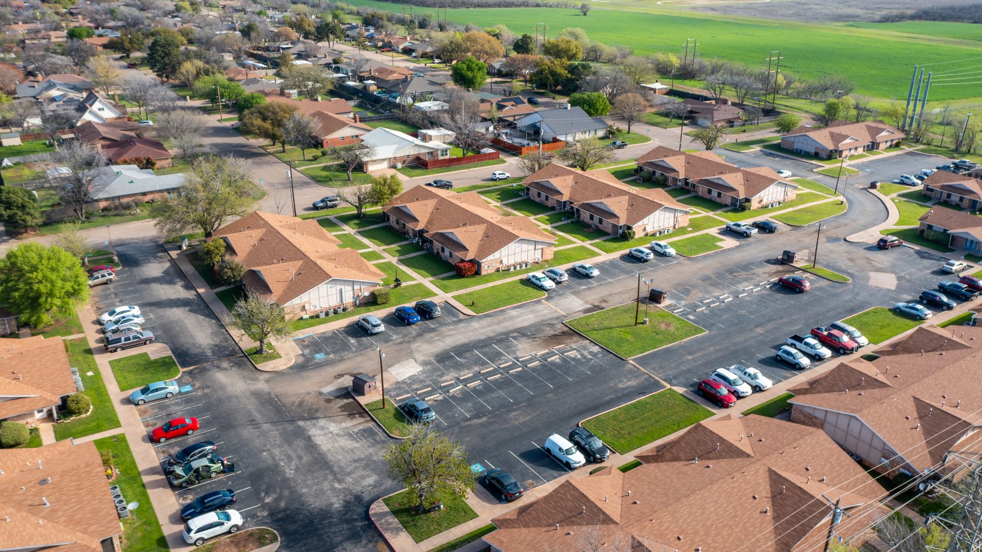 aerial view of residential neighborhood with cars parked on the street at The Sunscape Apartments