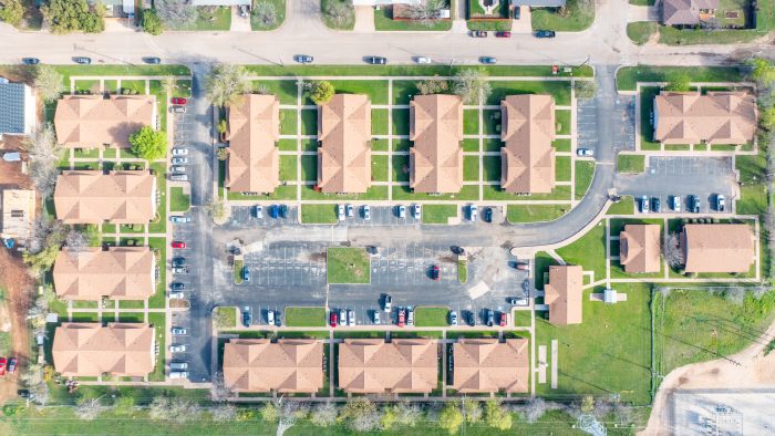 aerial view of a residential neighborhood with a green lawn at The Sunscape Apartments